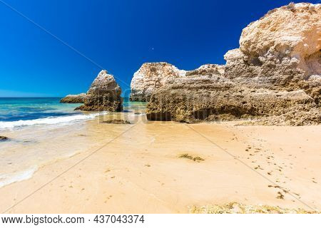 Aerial and panoramic view of Praia dos Tres Irmaos beach, Alvor, Algarve, Portugal