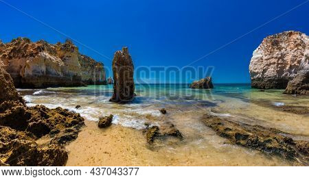 Aerial and panoramic view of Praia dos Tres Irmaos beach, Alvor, Algarve, Portugal