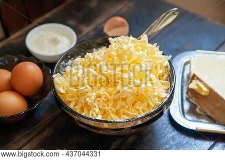 Grated Butter For Baking. Baking Ingredients For Shortbread Pastry: Butter, Eggs, Sour Cream On A Wo