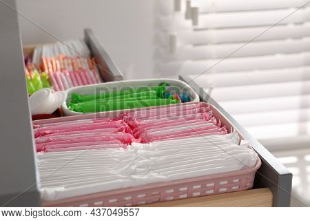 Open Cabinet Drawer With Menstrual Pads, Tampons And Pantyliners Indoors, Closeup