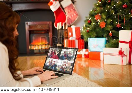 Caucasian woman on christmas tablet video call with diverse group of friends. christmas, festivity and communication technology.