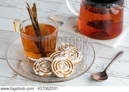 Cinnamon Swirl Cookies On A Plate With A Cup Of Cinnamon Chia Tea.