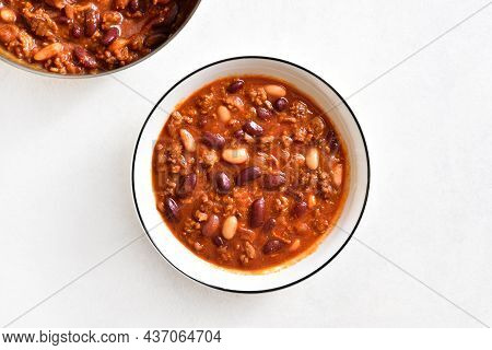 Stewed Beans With Ground Beef, Jalapeno Pepper And Bacon In Bowl Over Light Stone Background. Top Vi