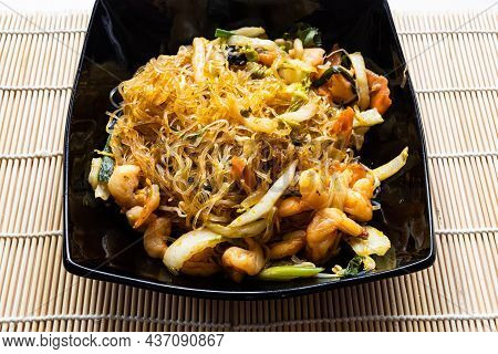 Portion Of Mien Xao Vietnamese Wok Stir-fried Glass Noodles With Vegatables And Prawns In Black Bowl