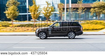 Moscow, Russia - August 2021: Range Rover L405 Rides On A City Road. Dark Brown Crossover Car On Str