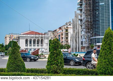 Shkoder, Albania - June 21, 2021: City Traffic On The Road In Front Of The Teatri Migjeni Building I