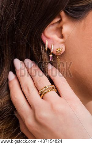 Earrings And Ring On A Beautiful Girl Close-up- Gold Jewelry With Stones