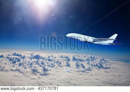 Big Jet Plane Fly Above Clouds At High Altitude