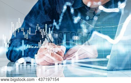 Office Man Writing, Signing A Contract, Computer On The Table. Double Exposure Of Growing Stock Mark