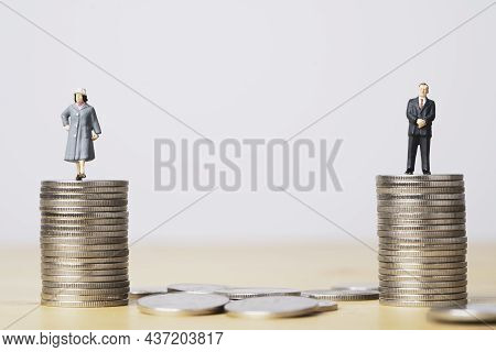 Miniature Figure Of Businessman Standing On Equal Coins Stacking Of  Businesswoman For Equality Of G