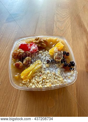 Take Away Traditional Turkish Dessert Is Asure Or Noah's Pudding On Wooden Table.
