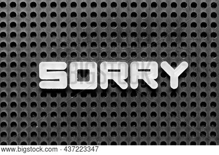 White Alphabet Letter In Word Sorry On Black Pegboard Background