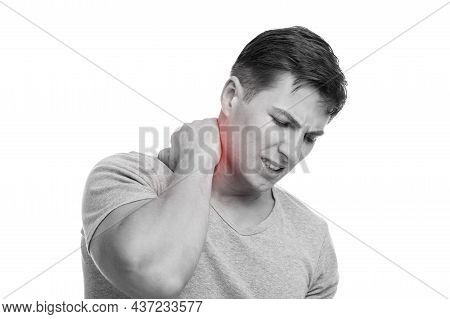 Sad Millennial Caucasian Muscular Man Suffer From Neck Pain, Presses Hand To Sore Spot, Highlighted 