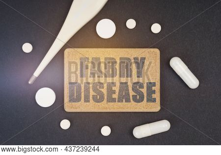 Medicine Concept. On A Black Background, A Thermometer, Pills And A Plate With The Inscription - Fab
