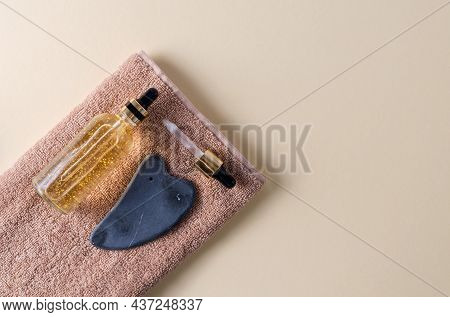 Gel Serum In A Glass Bottle With A Pipette And Gouache Made Of Natural Stone On A Brown Towel And A 