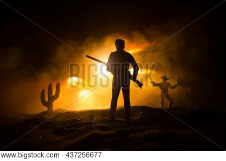 Western Cowboy Silhouette With Texture At Sunset And Slivers Of Light