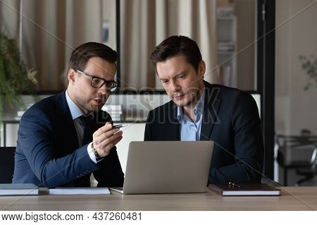 Young Man Insurance Broker Consult Client On Workplace Before Pc