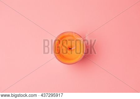 World Day Of Lighted Candles. An Orange Extinguished Candle On A Pink Background. Flat Lay. Copy Spa