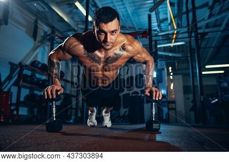 Fronr View Of Muscled Athlete, Bodybuilder Workouts Alone At Sport Gym, Indoors. Concept Of Sport, A