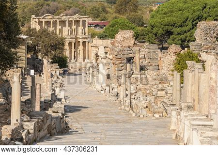 Historic Curetes street in Ephesus Ancient City at sunny day in Selcuk, Turkey. Hadrian temple, Library of Celsus and other famous ruins in Ephesus UNESCO World Heritage site.