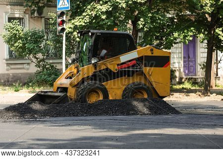 Modern Skid Loader On City Street. Road Repair Service