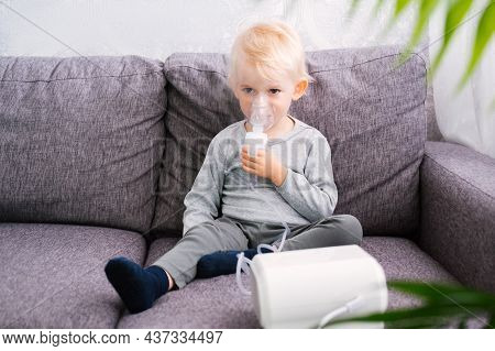 Cute Little Blond Boy Does Inhalation At Home.