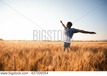 Unspecified Man With Hands Up Watching Sunset