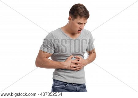 Unhappy Young European Male Suffering From Stomach Pain, Pressing Hand To Body