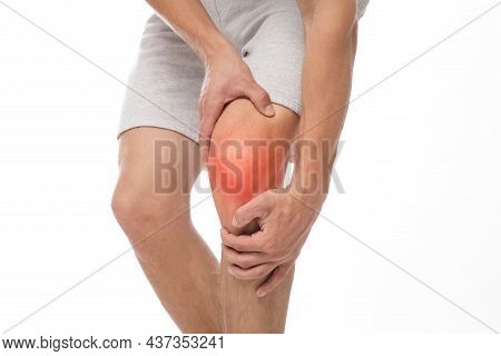 Unrecognizable Young Caucasian Guy Suffering From Knee Pain, Presses Hand To Sore Spot, Inflammation