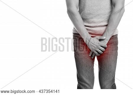 Millennial Caucasian Man Suffering From Groin Pain, Presses His Hand To Crotch, Highlighted In Red, 