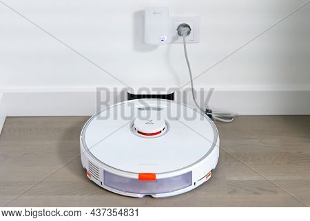 Tallinn, Estonia - October 10, 2021: Xiomi S7 Roborock Vacuum Cleaner On Charging Dock Station. Clos