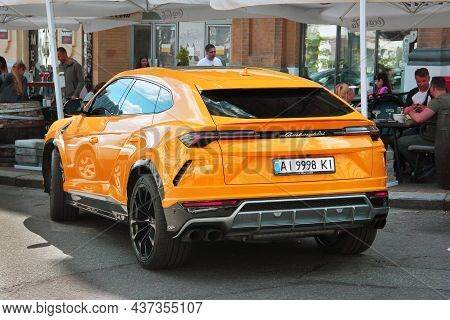 Kiev, Ukraine - May 22, 2021: Orange Luxury Super Suv Lamborghini Urus In The City. Lamborghini Urus