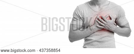 Unrecognizable Millennial Caucasian Guy Suffering From Chest Pain, Presses Hand To Sore Spot, Indica