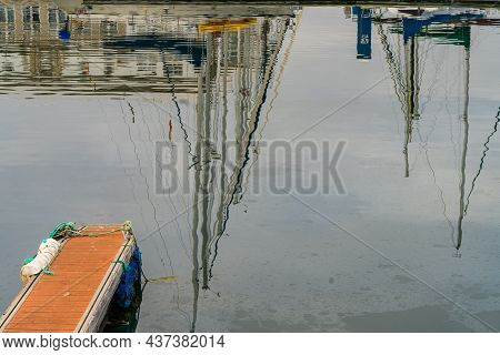Reflections In The Water Of Ship Masts In The Port Of A Coruna In Galicia, Spain