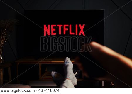 Online Streaming Service. Boy Hold Remote Control In Hand And Tv Set With Netflix Service Logo. Katy