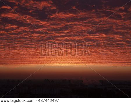 Red Ominous Clouds Hovering Above The Ground At Dawn. Red-tinted Sky At Sunrise. Landscape Of Tonal 