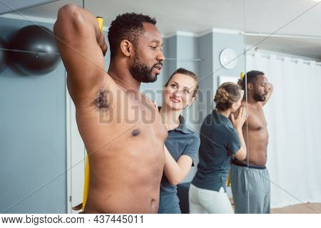 Young man receiving physical therapy on his shoulder