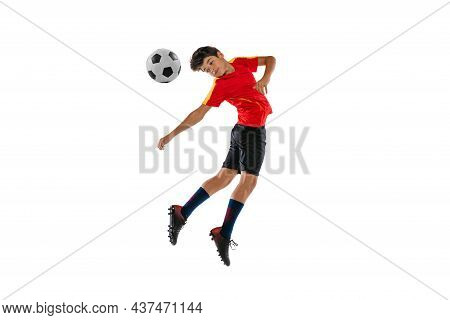 Portrait Of Boy, Teenager, Professional Football Player In Motion, Kincking A Ball With Head Isolate