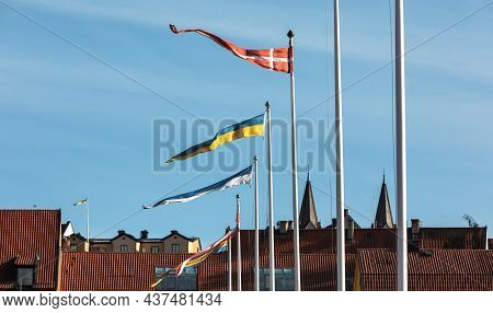 Visby, Gotland, Sweden- Oct 1, 2021: Flags Of Different Countries And Roofs Of The Old Ancient City 
