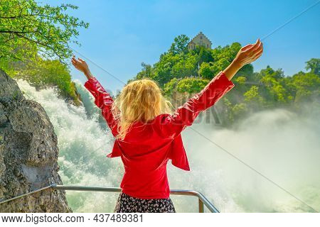 Woman Enjoing The The Swiss Waterfall Rheinfall In Switzerland. The Most Powerful And Big Waterfall 