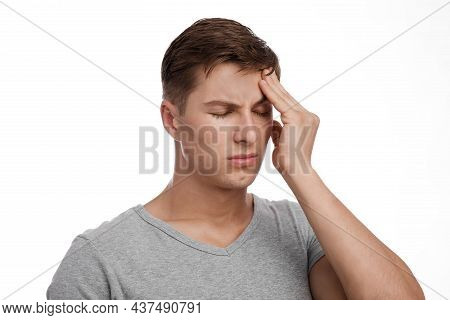 Despaired Sad Attractive Young Caucasian Guy Suffering From Headache, Touching Forehead, Isolated On