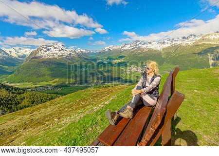Woman Relaxing On A Bench On Top Of Muottas Muragl Station Of The Famous Funicular Railway In Switze