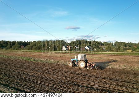 Tractor On Cultivating Field Work. Soil Tillage In Farmers Country. Agricultural Tractor On Cultivat