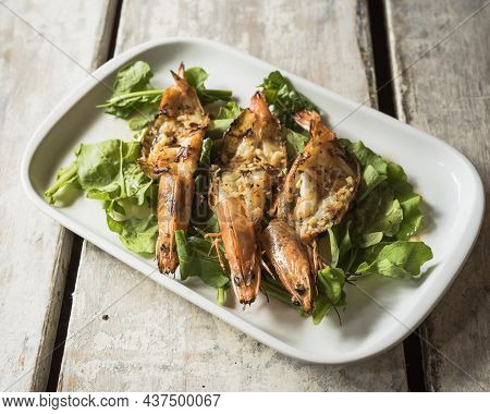 Grilled Shrimps With Garlic And Arugula From A Top View