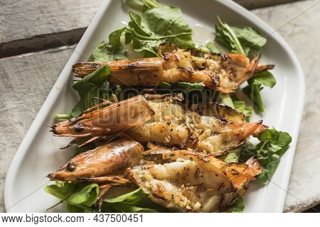 Grilled Shrimps With Garlic And Arugula From A Top View