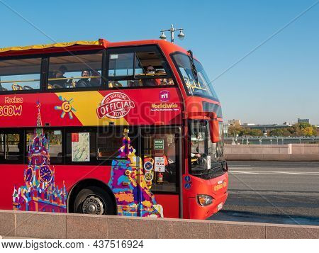 Moscow, Russia - October 5, 2021: Red Tourist Bus Travels Across The Moskvoretsky Bridge. People On 