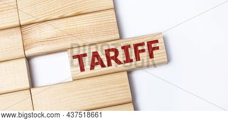 On A Light Background, Wooden Blocks With The Text Tariff. Close-up Top View.