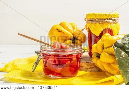 Ripe Whole Quince And Sweet Jam From It Isolated On White Wooden Background