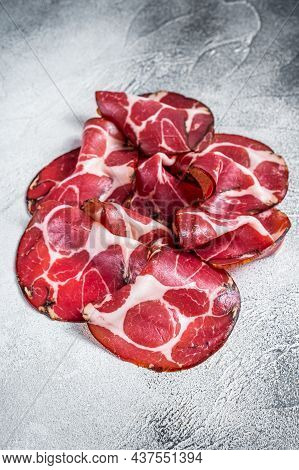 Coppa Cured Ham On Kitchen Table. White Background. Top View