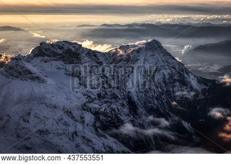 Aerial View Of Canadian Rocky Mountains With Snow On Top During Fall Season Sunset. Nature Landscape